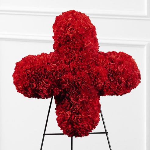 red cross flower standing spray delivery with crimson red carnations