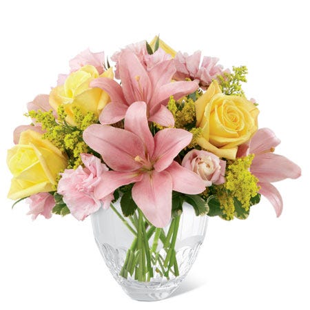Pink lilies with yellow roses in a glass vase from send flowers.com
