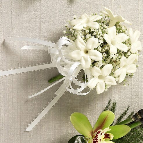 White flower corsage with cheap flowers and white stephanotis for same day delivery