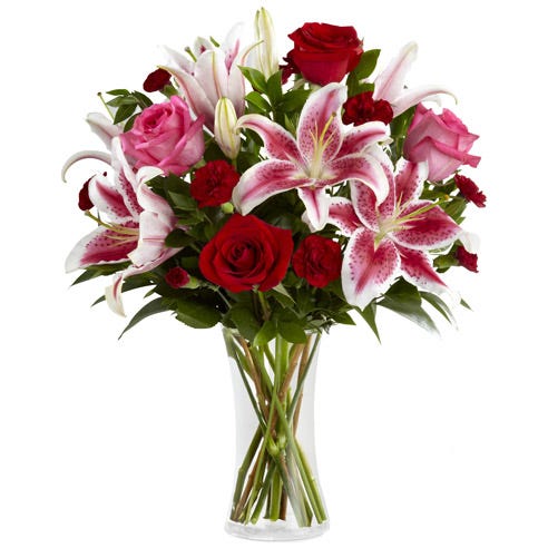 Burgundy stargazer lily bouquet with dark stargazer lilies and red roses in vase