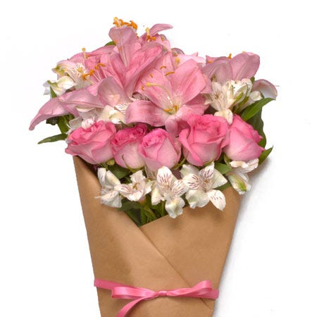 Paper wrapped pink rose, pink lily, and white alstroemeria bouquet