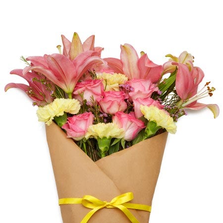 Pink rose and lily wrapped parchment paper wrapped flower bouquet delivery