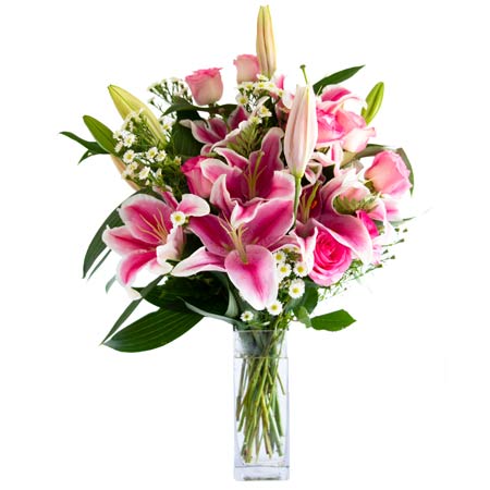 Pink rose and stargazer lilies in glass vase