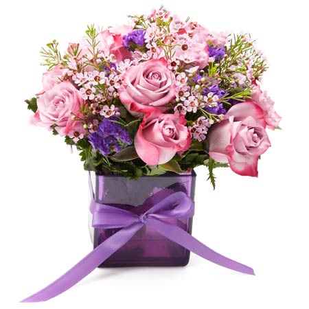 Purple bicolor rose bouquet with violets a lavender flowers in purple vase