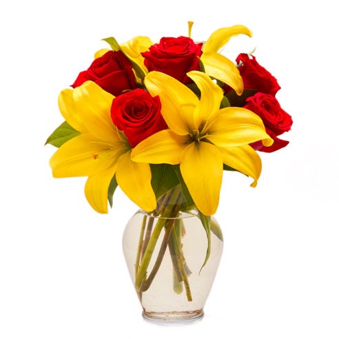 A Bouquet of Yellow Asiatic Lilies, Red Roses and Salal Tip in a Clear Vase