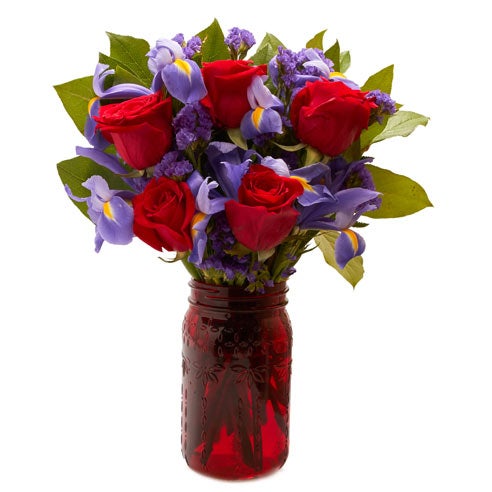 A Bouquet of Red Roses, Purple Static, Blue Iris and Salal in a Red Mason Jar