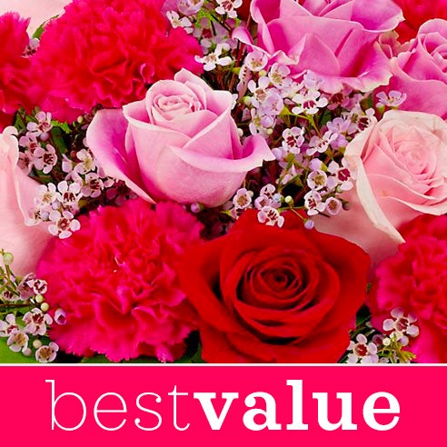 A Bouquet of Red Roses, Pale Pink Carnations, Ruby Mini Carnations, White Daisy Spray Mums in a Dark-Red Glass Vase with Decorative Bow and Message Card