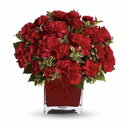 A Bouquet of Red Full And Mini Carnations and Colorful Glass Cube Vase