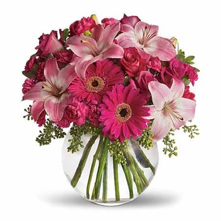 Adorable neon pink flower bouquet in round glass vase