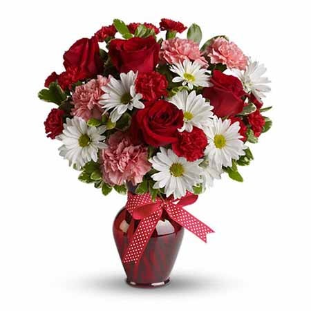 A Bouquet of Red Roses, Pale Pink Carnations, Ruby Mini Carnations, and White Daisy Spray Mums in a Dark-Red Glass Vase with Decorative Bow and Message Card