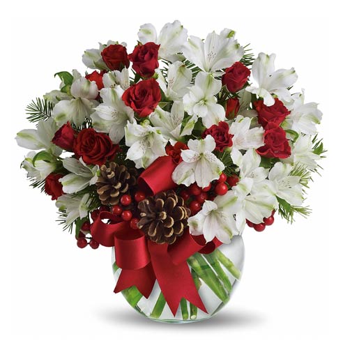 A bouquet of Red Spray Roses, White Alstroemeria, Douglas Fir, Berries in a  Clear Bowl with Pine Cones