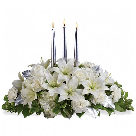 White lily centerpiece with white lilies, white hydrangea and carnations and candles