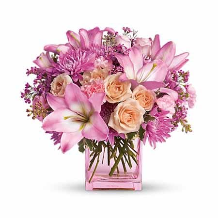 Bright pink lil and pink carnations flowers bouquet in pink glass vase