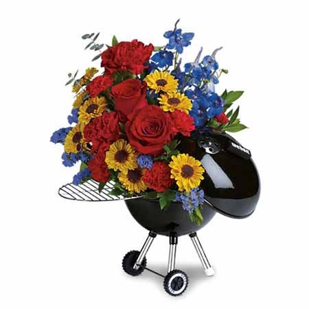 Red Carnations, Light Blue Delphiniums, Yellow Viking Daisy Spray Mums, and Blue Sinuata Statice in a Keepsake Grill Container