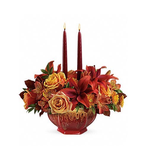 Peach roses, Burgundy lilies and candles create a rustic centerpiece