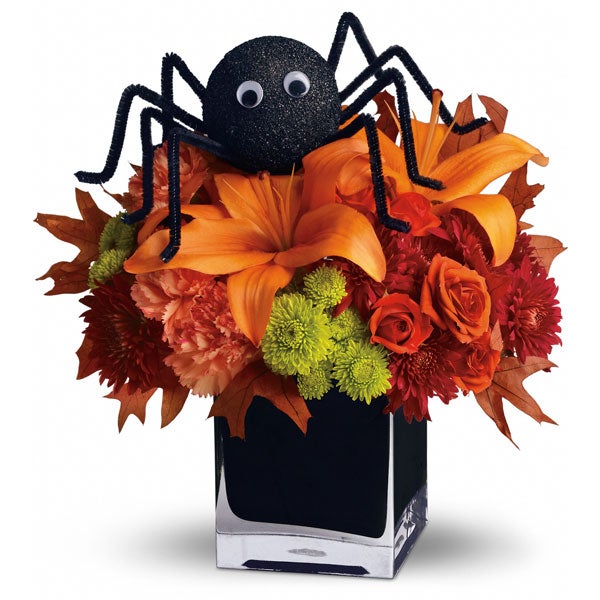 A Bouquet of Orange Roses, Orange Carnations, and Orange Asiatic Lilies with Spider Decoration in a Black Glass Cube Vase