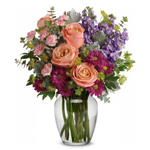 Mixed bouquet of flowers in a vase with pale pink roses, a vintage flower bouquet