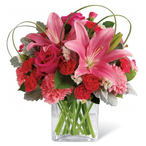 Pink lilies, red roses and carnations in a square heart vase