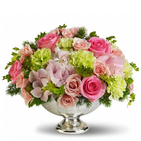 Centerpiece flower arrangement including Hot Pink Roses, Pink Hydrangea, Green Carnations, and Light Pink Spray Roses in a Silvery Mercury Glass Bowl