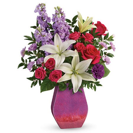 White lily, pink rose, lavender stock and purple carnations glitter vase bouquet