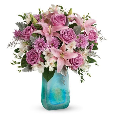 Pink asiatic lily, purple roses and lavender chrysanthemums bouquet in blue vase