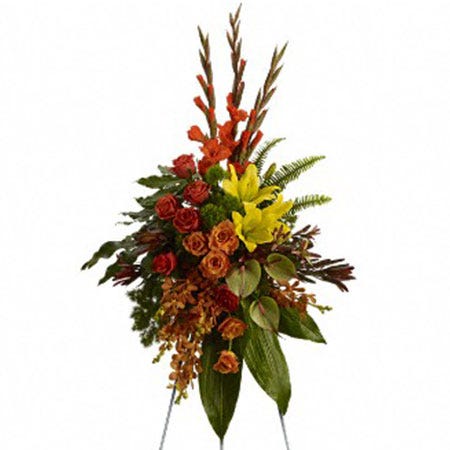 Orange orchid, orange rose, and red gladioli oval funeral flowers standing spray
