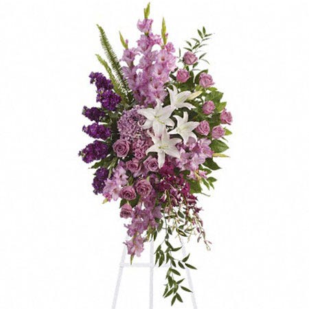 Oval shaped lavender roses and gladioli funeral flowers standing spray