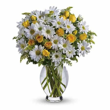 White daisy and miniature yellow roses bouquet in glass vase of spring flowers