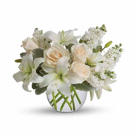 White asiatic lily and cream roses bouquet with white stock flowers and bubble vase