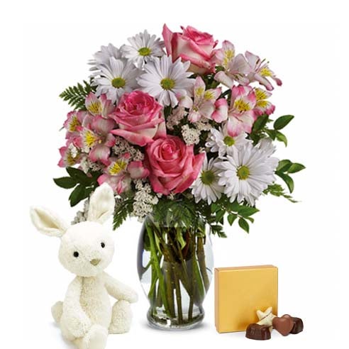 Easter bouquet next to a plush bunny and Easter candy