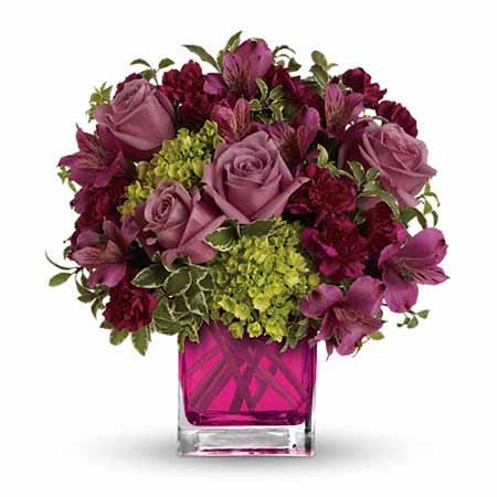 dark purple flowers with purple roses in purple glass vase