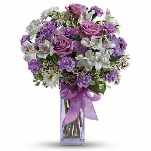 A Bouquet of Purple Roses, White Alstroemeria, Miniature Lilac Carnations, White Mums and Waxflowers in a Light-Purple Vase