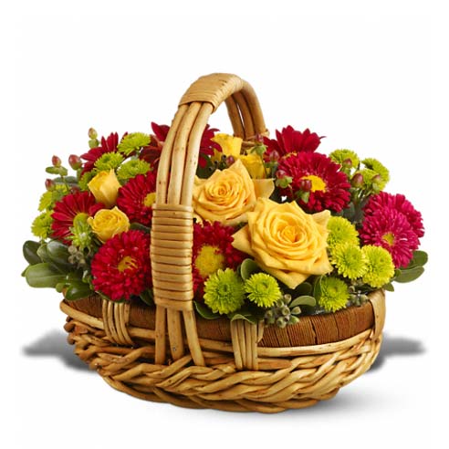 Yellow Roses, Yellow Spray Roses, Green Button Spray Chrysanthemums, Red Daisy Spray Chrysanthemums, Red Matsumoto Asters, Green Pittosporum, Brown Hypericum and Seeded Eucalyptus on a Basket with Handle