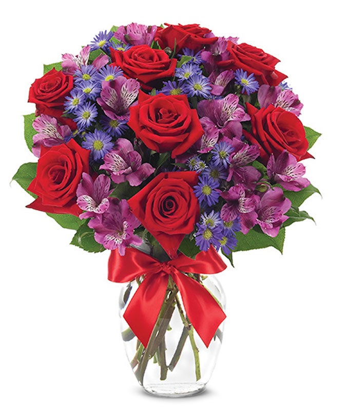 A Bouquet of  Red Roses, Purple Alstroemeria, Purple Flowers, and Purple Monte Casino in a Glass Vase with Decorative Bow