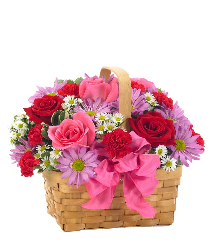 Pink and red roses delivered by a florist in a woven basket