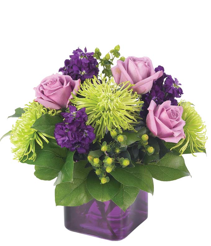 Purple flower arrangement with roses delivered in a lavender vase