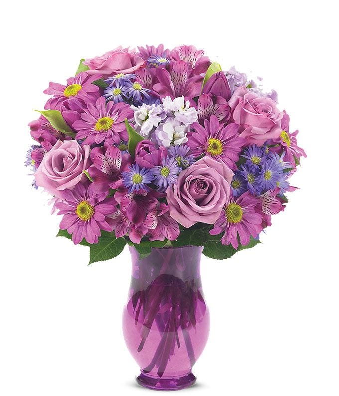 Purple roses delivered with purple alstroemeria and tulips in a purple vase