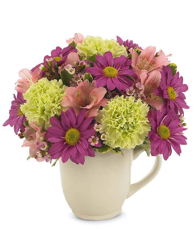 Purple daisies and pink flowers in a reusable mug