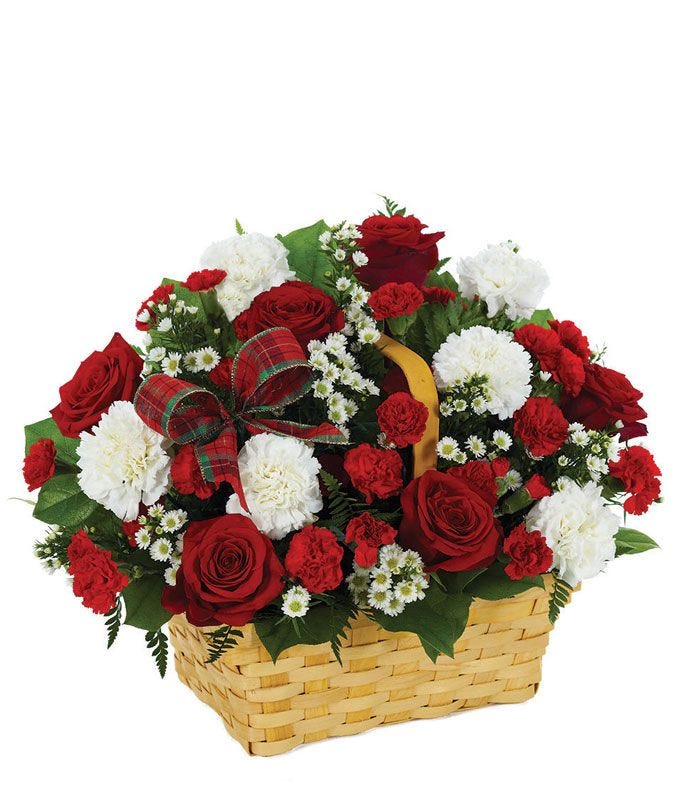 Basket of holiday flowers with red roses and carnations