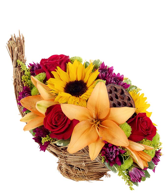 Cornucopia flower bouquet centerpiece with sunflowers and red roses in basket