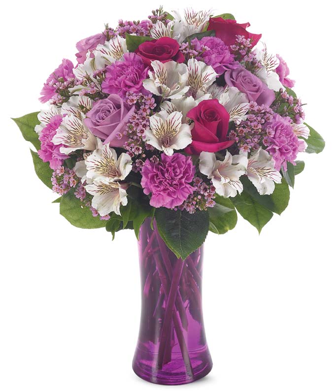 Purple roses, purple carnations and white alstroemeria in a purple vase