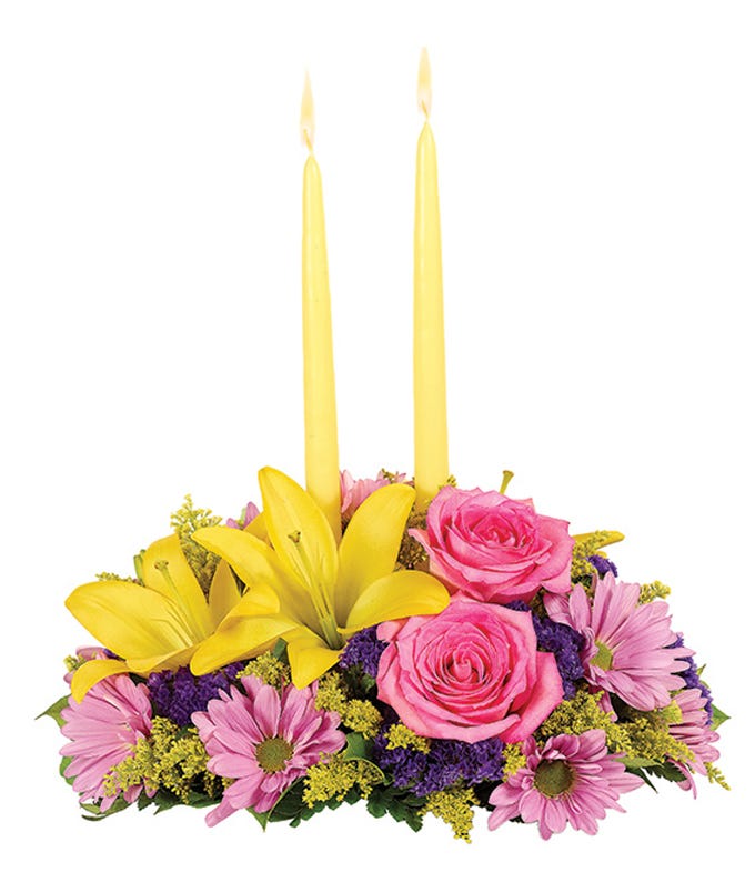 Pastel spring flower candle centerpiece with two tall yellow candles