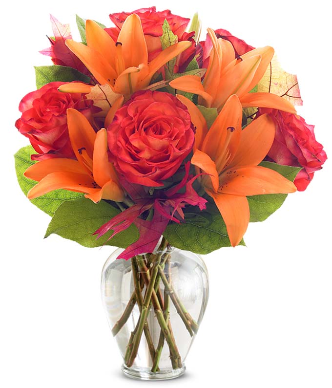 A Bouquet of Orange Roses and Apricot Lilies in a Keepsake Glass Vase with Card Message Included