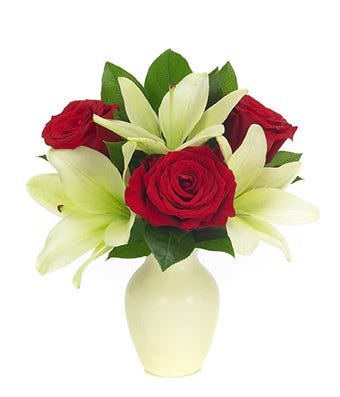 Red roses arranged with white lilies in a bud vase for same day delivery