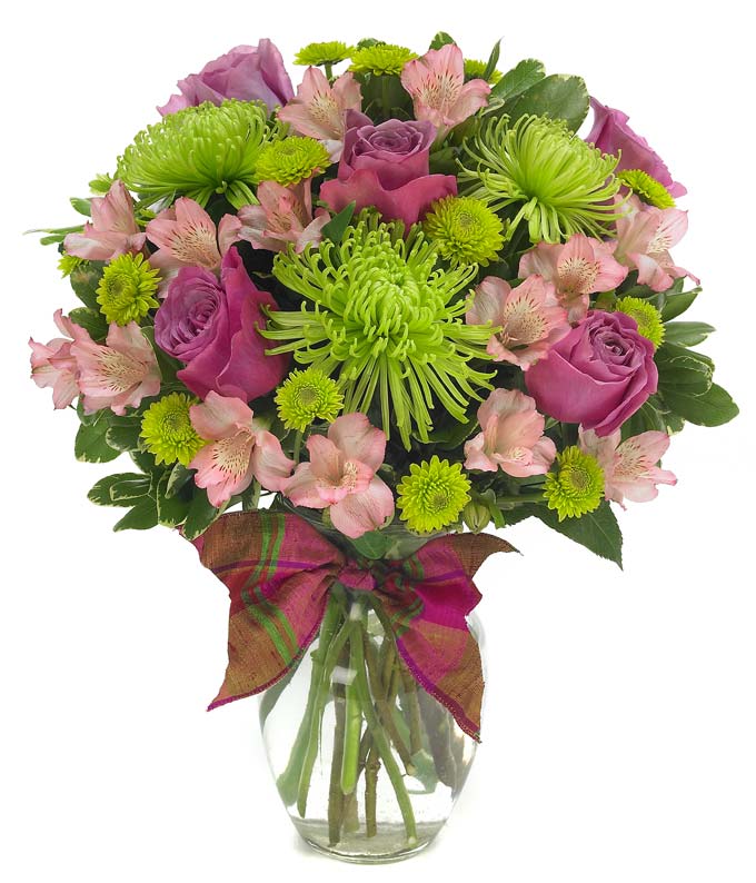 Purple roses, pink alstroemeria and green spider mums in glass vase