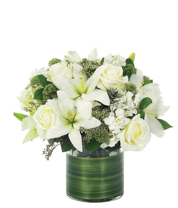 White roses and white lilies delivered in a circular vase 