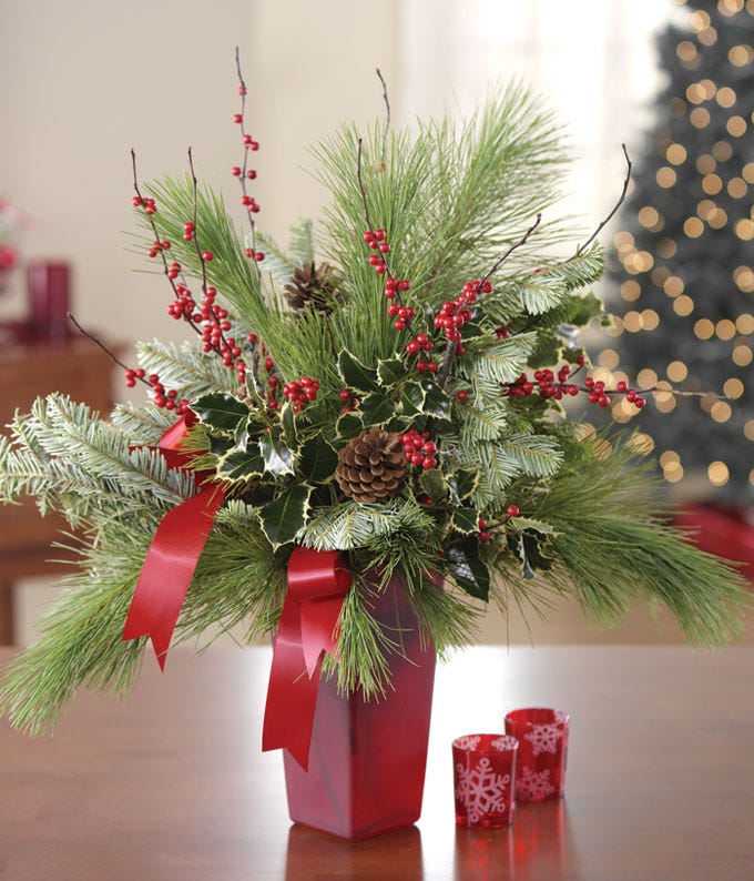 Evergreen Christmas arrangement in red vase