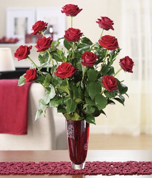 One dozen long stem red roses delivered in a red valentine vase