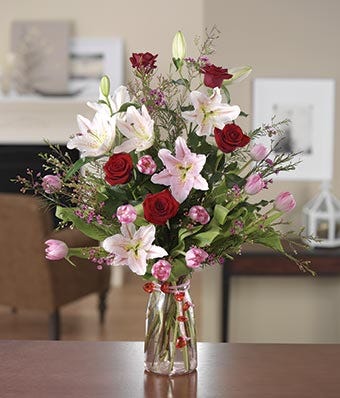 Large arrangement with red roses, pink tulips and pink lilies