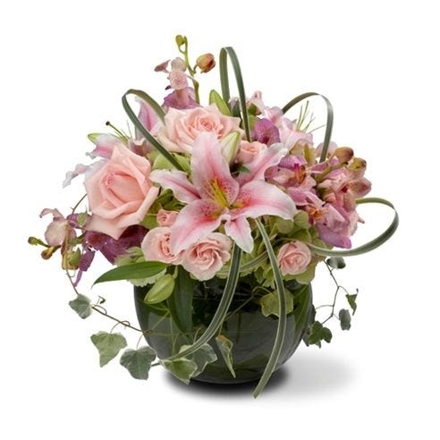 Pink lilies, pink orchids and white lilies delivered in circular arrangement